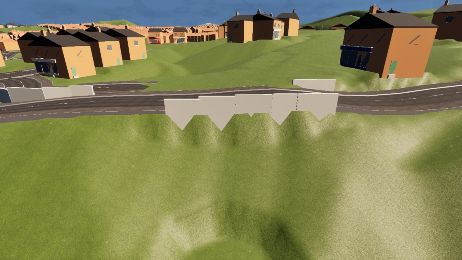 A grassy bank below a road on a hillside estate of simple brick-coloured houses. A row of pale retaining wall panels stands along the road edge, and where the bank meets the wall the bottom edge reads as a row of downward-pointing V-shaped teeth.