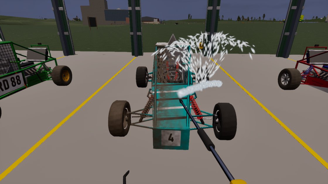 First-person view inside a garage of racing buggies parked in yellow-lined bays. A pressure washer lance sprays a burst of white water over a teal buggy numbered 4, whose frame is part clean and part streaked with mud; a green and a red buggy are parked either side.