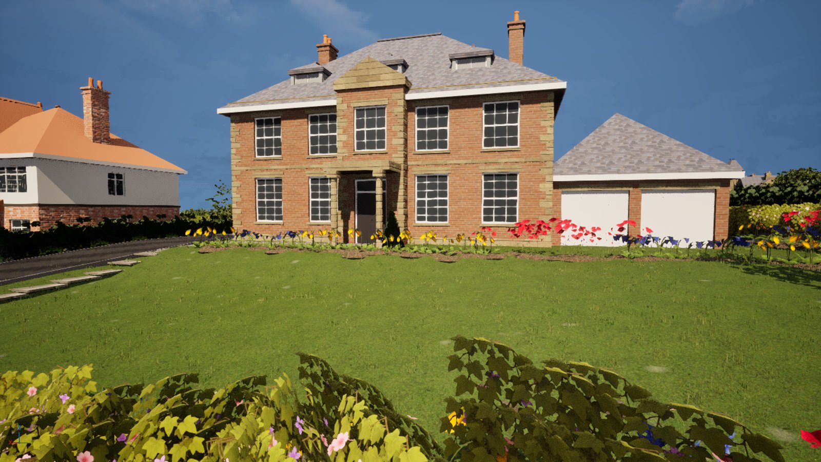 The same red-brick house and double garage from the same spot. The sky is clear, and a strip of yellow, blue and red flowers now runs along the foot of the house and the garage on dark soil beds, with a green cone of topiary by the front door.