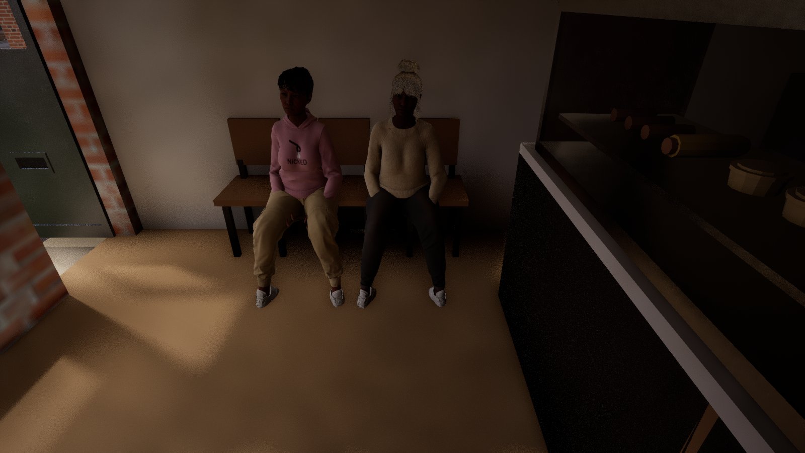 Inside a chip shop from above: two women sit side by side on a wooden bench against the wall, hands in their pockets and feet on the floor, one in a pink hoodie and one in a cream jumper, with the dark serving counter on the right.