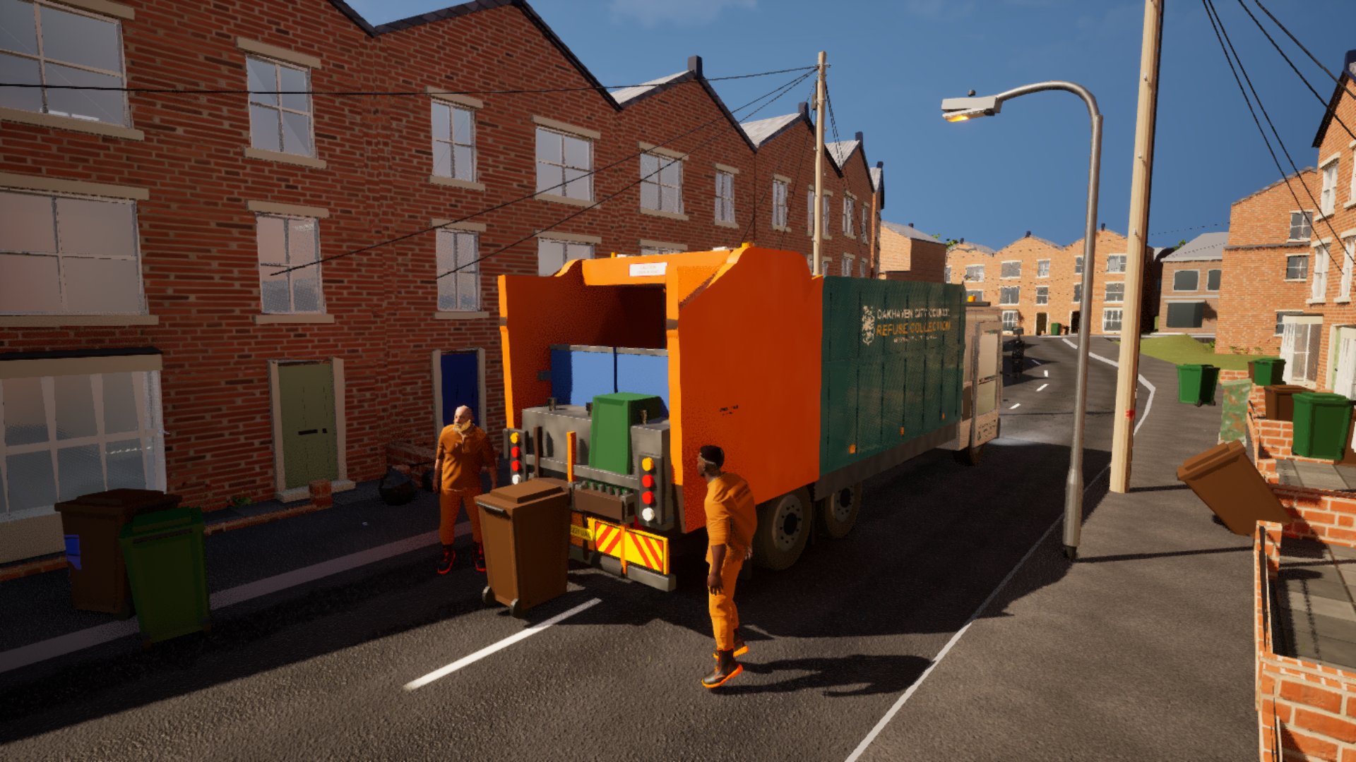A wheelie bin raised on the lifting comb at the back of the bin lorry while a loader walks the next bin up from the pavement.