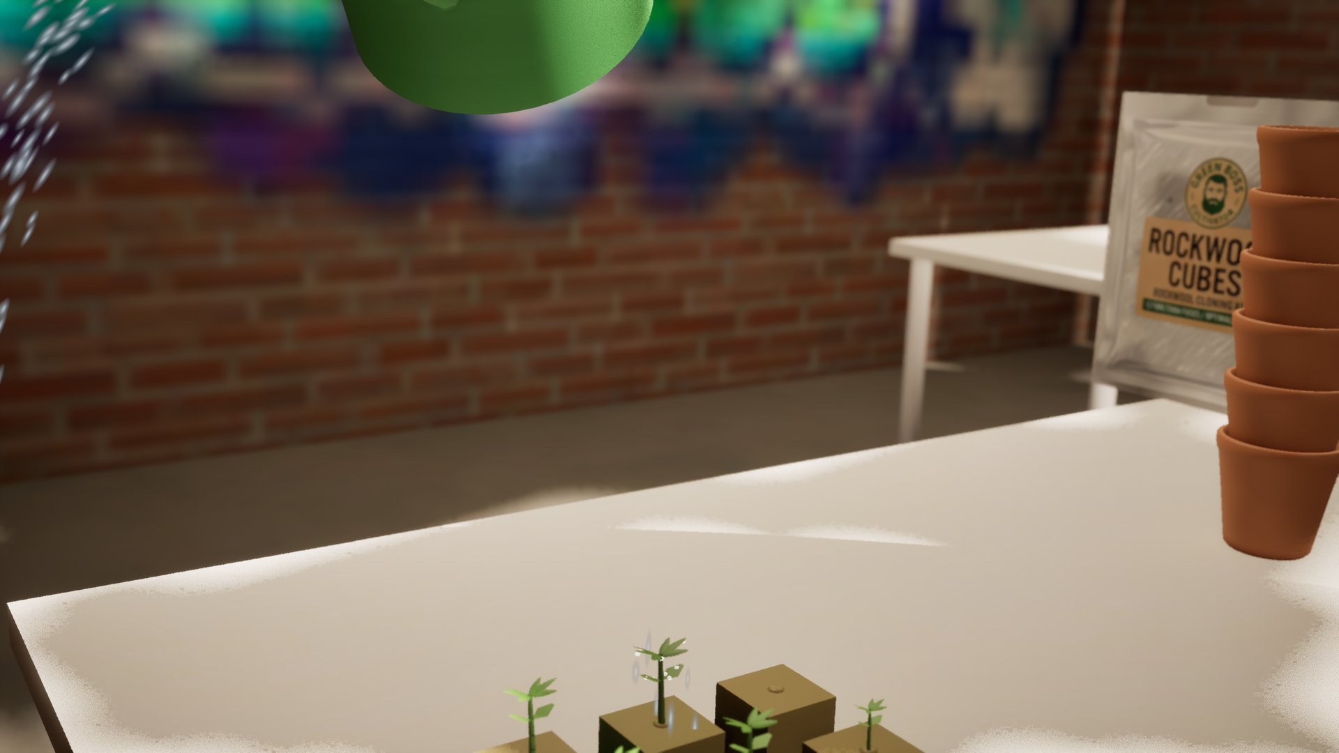 A green watering can tipping water over a tray of rockwool cubes on a white table, the first green shoots poking out of them, terracotta pots stacked at the side.